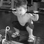 Small child lifting a weight bar